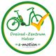 Grünes Logo mit einem Dreirad und gelbem Haken. Text: "Dreirad-Zentrum Halver, e-motion".