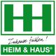 Grünes Logo von Heim & Haus mit Slogan "Zuhause fühlen!".