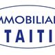 Logo con testo "Immobiliare Taiti" in blu, racchiuso in un ovale.