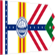 Flag with vertical stripes, central emblem, red chevrons, white background, and green triangle.