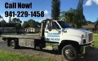 Tow truck parked on grass, with contact number "941-229-1458" displayed above.