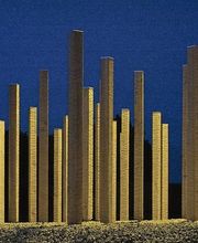 Holzpfeiler erleuchtet im Dunkeln, auf Steinen stehend, vor einem blauen Nachthimmel.