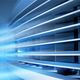 Close-up of blue-tinted ventilation slats with glowing streaks of light.