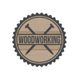 Woodworking logo with crossed nails on a wood-textured circle and a black jagged edge.