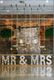 Industrial wedding decor with "MR & MRS" marquee lights, swings, and hanging greenery.