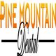 "Pine Mountain Dental logo with orange gradient text and stylized black 'Dental' script."