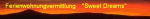 Roter Himmel bei Sonnenuntergang, Schriftzug "Ferienwohnungsvermittlung Sweet Dreams".