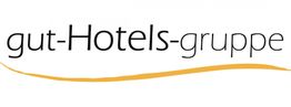 Logo der gut-Hotels-Gruppe mit schwarzem Text und geschwungener gelber Linie darunter.