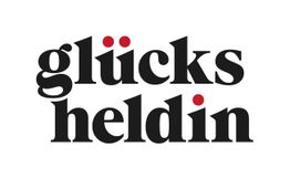 Schriftzug „glücksheldin“ in Schwarz mit roten Punkten auf weißem Hintergrund.