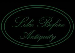 Testo verde elegante: "Like Before Antiquity" su sfondo nero.