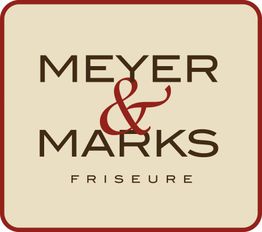 Logo mit der Aufschrift "Meyer & Marks Friseure" auf beigem Hintergrund mit rotem Rahmen.